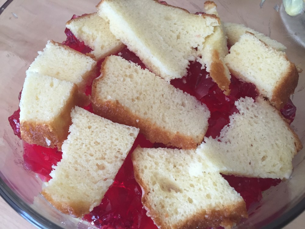 Layers of custared, jello, fruits and cake