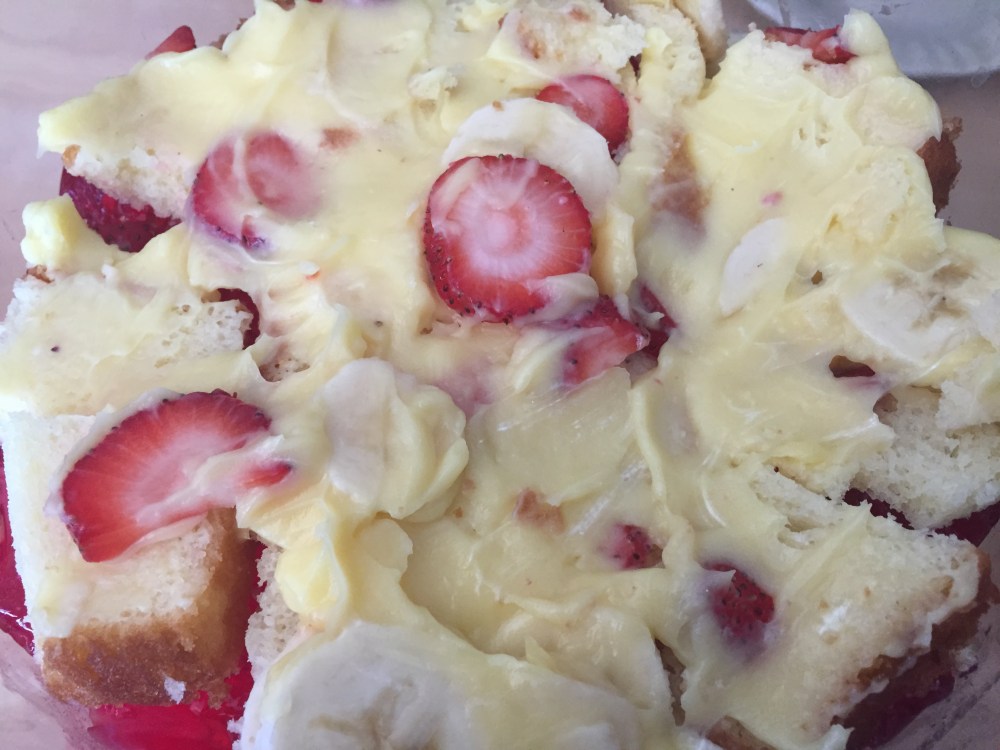 Layers of custared, jello, fruits and cake